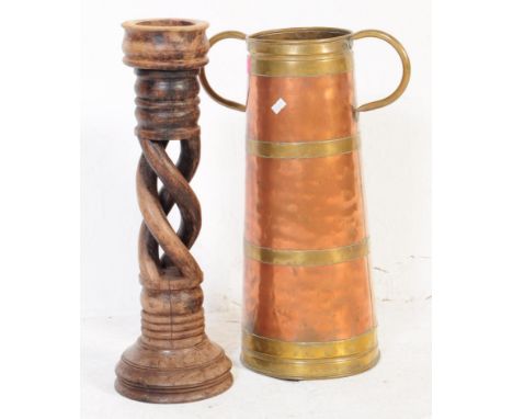 An unusual large copper and brass coopered twin handled stick stand jug. Cylindrical form with brass banding and coopered bin