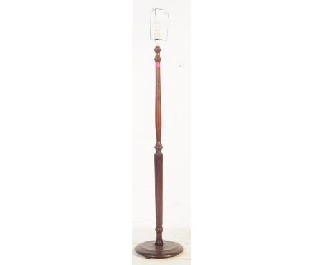 A 20th century mahogany floor standing standard lamp., The standard lamp having tapered and reeded shaft and being raised ove