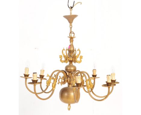 A 20th century Dutch eight arm brass chandelier. The chandelier having anthropomorphic creatures to fixture with Maltese dolp