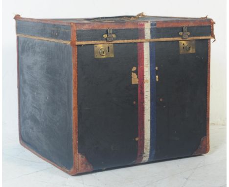 An early 20th century French steamer travel case trunk. Having stitched tan leather binding to edges with dark blue panels an
