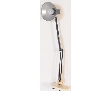 A retro 20th century black metal anglepoise articulated desk table lamp light. The light having a conical shade over an artic