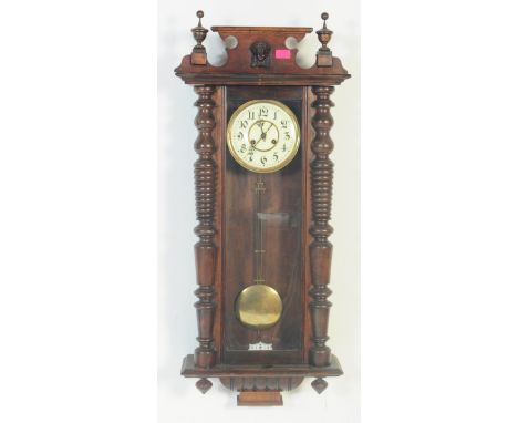 A 19th century large Vienna regulator wall clock. The large decorative oak case with glass window enclosing brass movement, d