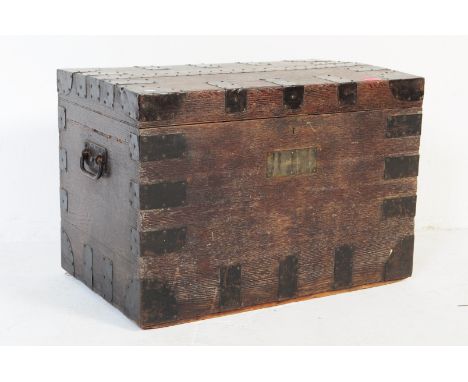 A late 19th century travel railway steam trunk chest. Rectangular form with black metal mounts, oak constructions with hinged
