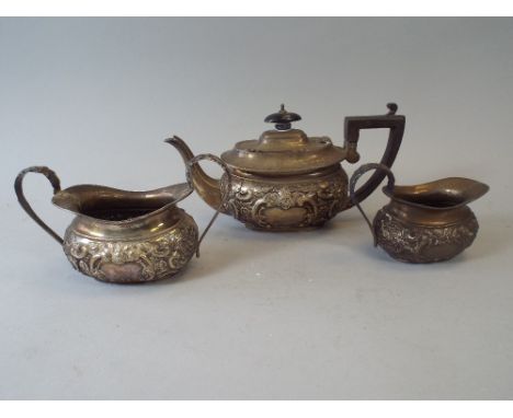 A Silver Three Piece Bachelors Tea Service with Embossed Decoration, Chester 1900, 596g, 