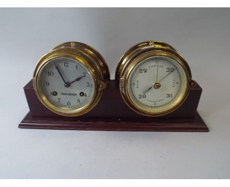 A Brass Ship's Clock and Brass Ship's Barometer Set in Mahogany Stand.