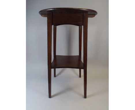 An Oak Circular Topped Occasional Table with Stretcher Shelf.