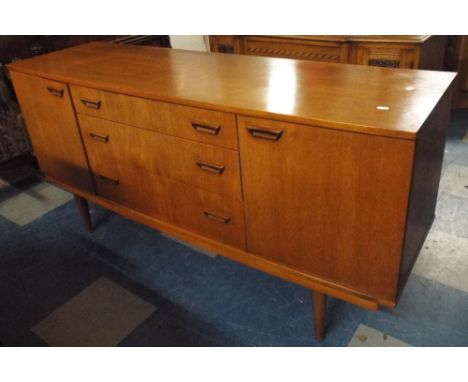 A 1970's Bow Fronted Sideboard with Three Centre Drawers Flanked by Two Cupboards.