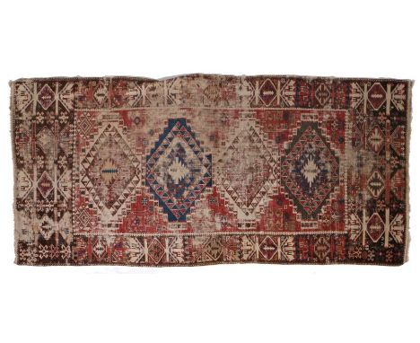 A Persian Kilim, set with animal motifs, diamond lozenges and various guls, with a red blue and cream ground, 220cm by 101cm&