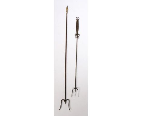 An 18th Century steel toasting fork, with three prongs and a flattened handle with etched design, a looped heart to the top, 
