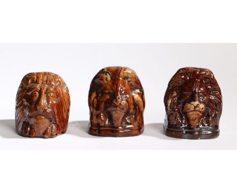 Three 19th Century sash window pottery jams, each in treacle glaze with lion masks, 10.5cm wide, (3)