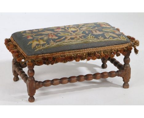 An 18th Century walnut and wool work stool, the wool work top with a bird in a pear tree and a fox below, the bobbin turned b