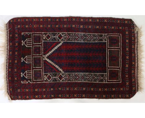 A Turkmen prayer rug, Central Asia, with a Kochak style central design surrounded by a chevron and diamond pattern together w