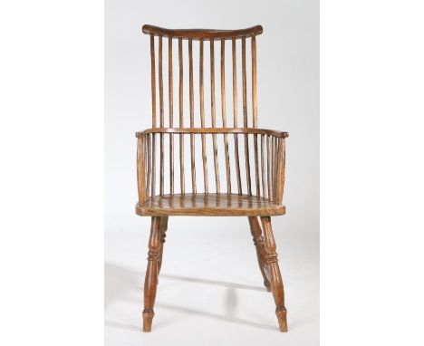 A late 18th Century ash and elm comb back Windsor chair, circa 1800-1820, West Country, the curved top rail above a spindle b