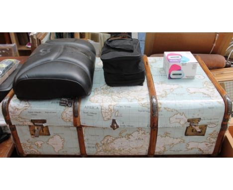 A banded trunk decorated with map material together with a massage cushion, DVD player etc
