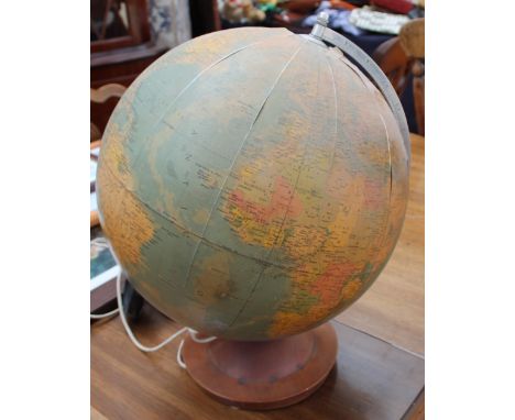 An electrified globe on a turned wooden base