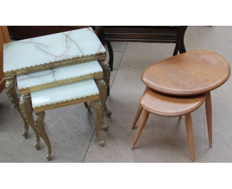 A nest of two Ercol pebble tables together with an onyx and brass nest of three tables and a piano stool