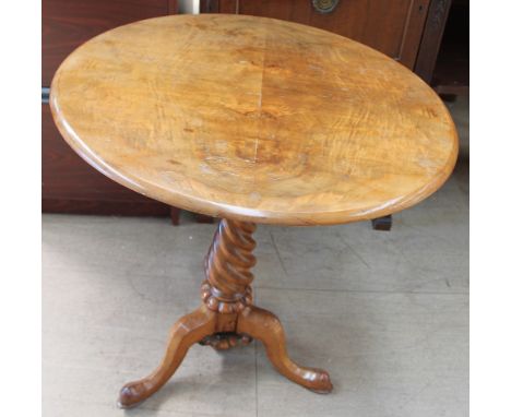 A Victorian walnut tripod table, the circular top on a tapering rope twist column and three legs with pointed pad feet