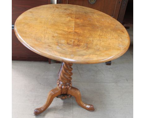 A Victorian walnut tripod table, the circular top on a tapering rope twist column and three legs with pointed pad feet