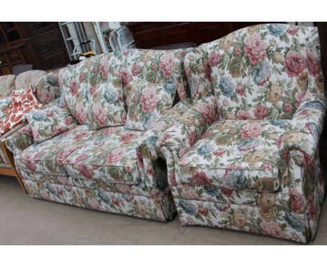 An upholstered two seater sofa bed together with a matching arm chair