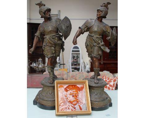 A pair of spectre figures of warriors together with a framed pottery tile