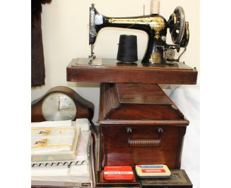 A cased singer sewing machine together with a mantle clock, tins, linen etc