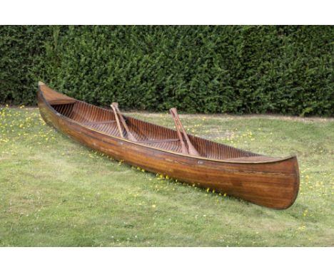 Boats: A cedar strip canoe by the Lakefield Canoe Company, with two pairs of paddles and applied makers’ plaques , length 485