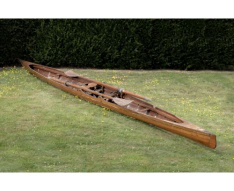 Boats: A wooden skull, mid 20th century, sliding seat, with one outrigger together with a pair of oars, length 670cm