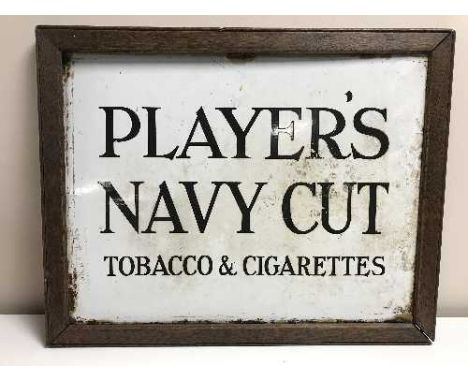 An oak framed Players Navy Cut Tobacco & Cigarette enamel advertisement 