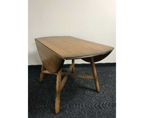 An Ercol elm drop leaf table 