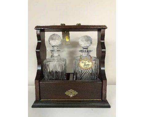 A mahogany two decanter tantalus
