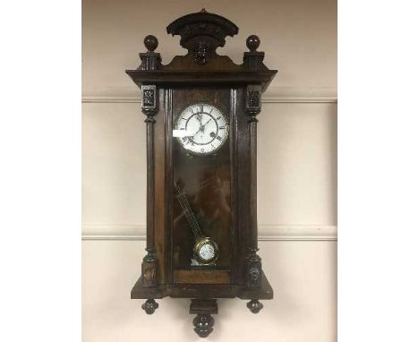 A mahogany wall clock with enamel dial