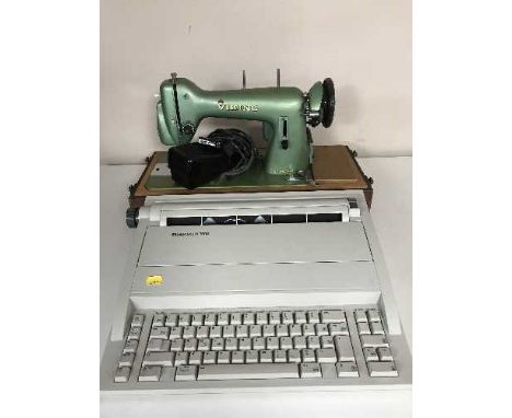 A cased Husquanvana sewing machine and a Silver Reed typewriter 