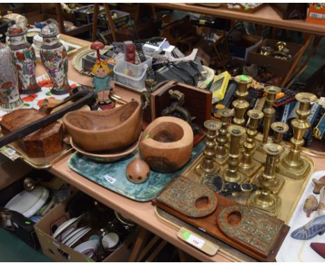 Three trays inc. a quantity of brass candlesticks, a book slide, treen, a tribal pick axe etc