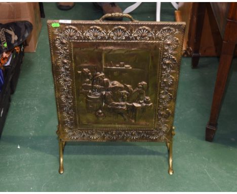 A brass firescreen