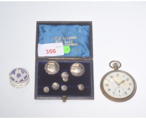 A group comprising: a Masonic silver pill box, stamped 925; a mid 20th century pocket watch, the dial signed Omega, the back 