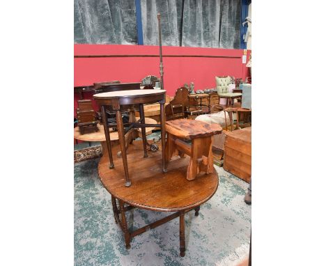 A group of furniture comprising a 1920s oak dropleaf table, a cast iron standard lamp, two occasional tables, a naturalistic 