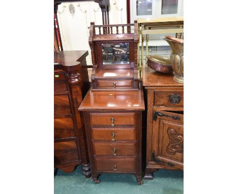 A late 19th Century/early 20th Century chest with superstructure with shelf above a mirror and drawer and with four drawers b