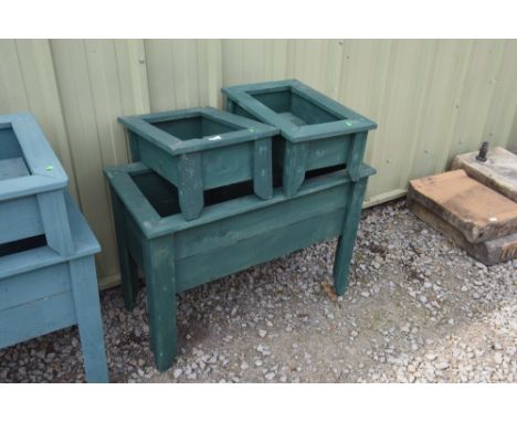 a large painted wooden plant trough; tog. with two similar smaller troughs