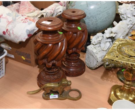A pair of carved wooden table lamps (fittings lacking); tog. with a vintage nut cracker