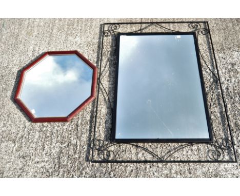 Two contemporary wall mirrors, the first with black painted metal scrollwork frame, 105.5 cm high, the second of octagonal se