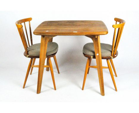 A pair of spindle back beech Ercol chairs with fixed seat pads; together with a modern Ercol-style table on splayed legs, 72c