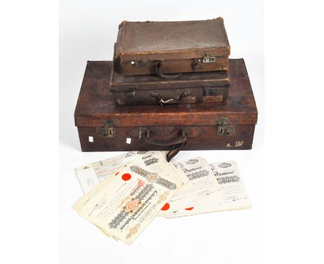 A vintage leather bound trunk, initialled J.K.H.R, together with two smaller cases, largest 20cm x 70cm x 40cm