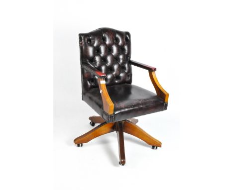 A modern Burgundy leather button back office chair on swivel support, and casters, height 87cm