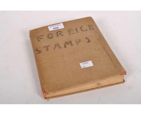 A 'Mercur' Postage stamp album First Edition, together with an assortment of stamps of various sizes and designs