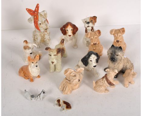 A quantity of Sylvac dog ornaments, featuring a variety of breeds, together with other ceramic examples 