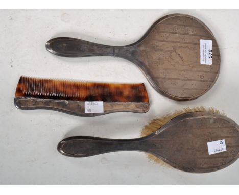 Three silver backed dressing table items, to include a brush, mirror and comb, hallmarked (3)