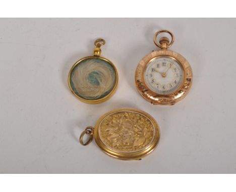 A 14ct gold cased ladies fob watch, white enamel dial with Arabic numerals and engraved case, together with a mourning locket