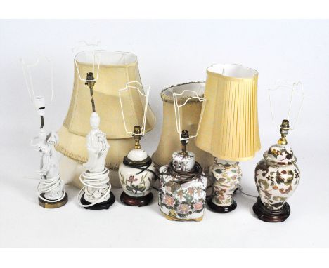 Six table lamps, two modelled as Asian figures in traditional attire glazed in white, together with four other lamps, all wit