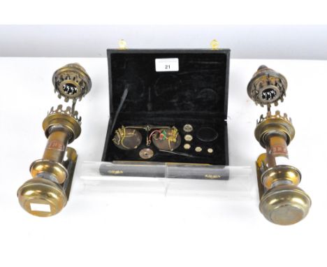 A pair of GNR glass and brass railway lamps, on original brackets, 34cm long, together with a cased set of weighing scales