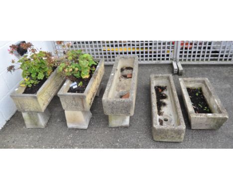 A collection of stone and composite stone planters, comprising: a pair on raised block feet with oak leaves,  two slightly sm